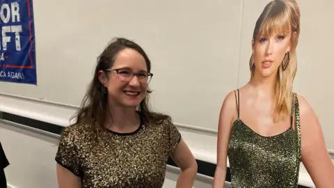 Dr Amy Skjerseth standing with a cardboard cut out of Taylor Swift