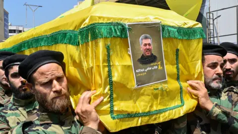 EPA Members of Hezbollah carry the coffin of commander Taleb Sami Abdullah at his funeral in Beirut, Lebanon (12 June 2024)