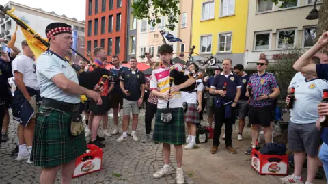 PA Media Scotland fans playing the bagpipes in Cologne during Euro 2024