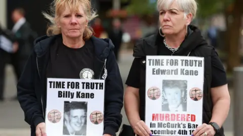  Liam McBurney/PA Campaigners displayed photos of loved ones killed in the Troubles outside court