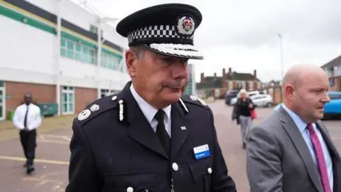 PA Media Man in chief constable uniform leaving venue