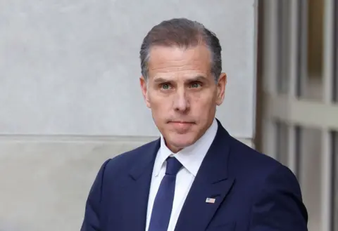 Getty Images Hunter Biden looks at reporters outside the Delaware courthouse on Monday