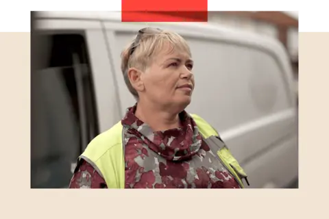 Irena, a woman with short blonde hair, stands in front of her delivery van