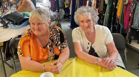 Jane Ann Williams and Debbie Bowen sat at a table