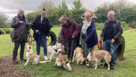 Rescued dogs with their new owners