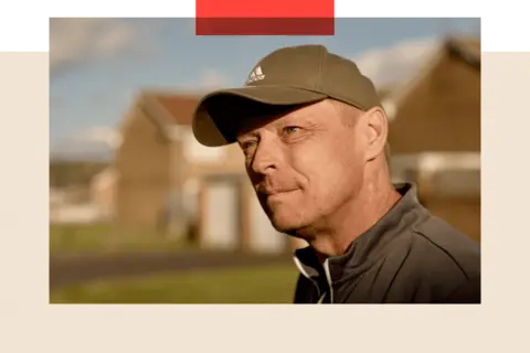 Close-up photo of Tony, a man with short hair in a baseball cap