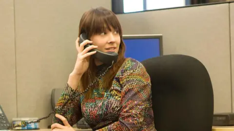 Getty Woman in the 70s on an office phone