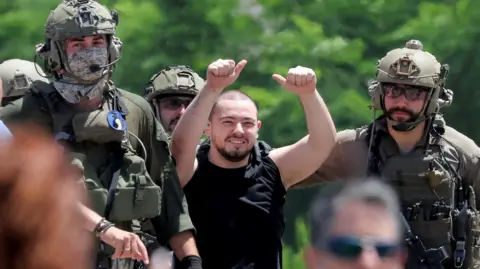 Reuters Israeli hostage Almog Meir Jan gestures after being rescued by Israeli forces in an operation in central Gaza, in Ramat Gan, Israel (8 June 2024)