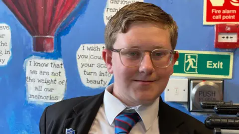 A young boy in glasses