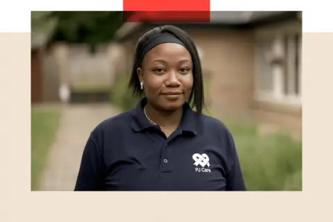 Rejoice, a woman in a blue t-shirt stands outside 