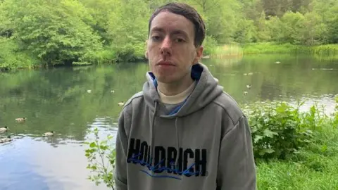 bbc Former inmate of Parc Prison, Leo Deacon, standing next to a lake 