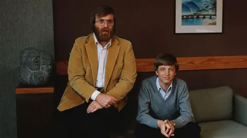 Getty Images Paul Allen and Bill gates sitting on a sofa and looking at the camera