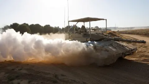 Reuters An Israeli tank manoeuvres, after returning to Israel from the Gaza Strip (5 June 2024)