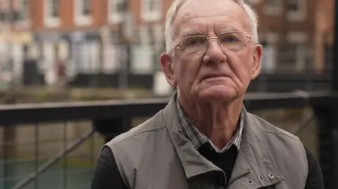 Tony Martin, a voter from Hull, stands on a street