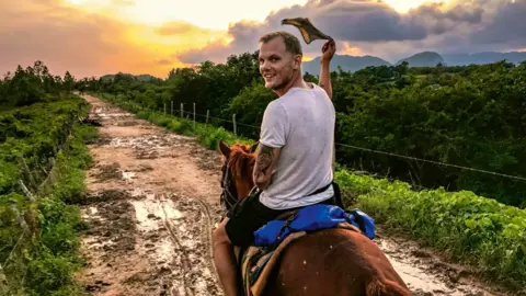 Private/Avicii Music AB Avicii riding a horse into a sunset