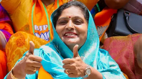 EPA Bharatiya Janata Party (BJP) supporters celebrate as they watch election election results on a television screen at BJP headquarters in Bangalore, India, 04 June 2024. 