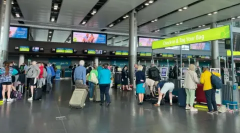 RTE Dozens of passengers at the bag drop area of Dublin Airport's Terminal 2