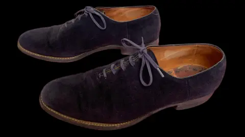 PA Media Blue suede shoes owned by Elvis which feature laces and a brown leather insole