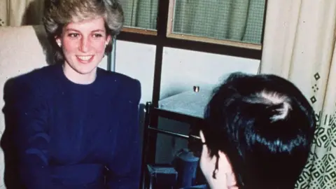 Getty Images Princess Diana shakes hands with an Aids patient