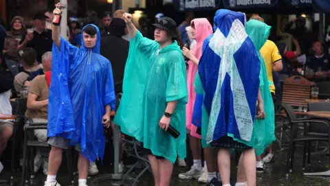 PA Media Scotland fans wearing ponchos in Cologne during Euro 2024