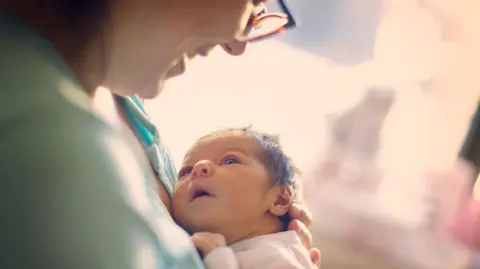 Getty Images  A woman and her baby