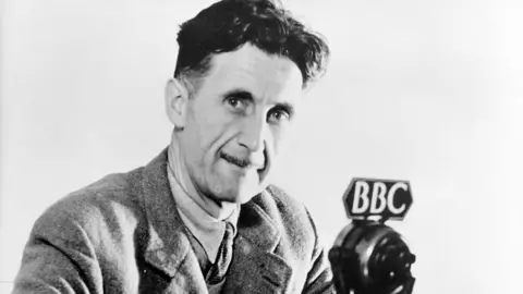 Getty Images George Orwell at a BBC microphone