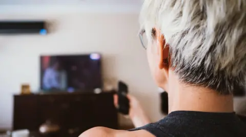 Getty Images A woman watching TV