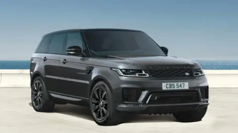 JLR Promotional image from JLR of a dark grey Range Rover with the sea in the background