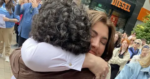 RTE Natasha O'Brien hugs a supporter at a rally in Limerick on Saturday