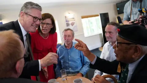 PA Media Labour leader Sir Keir Starmer meeting a veteran at a coffee morning at Aldershot Town Football Club