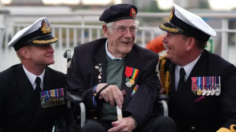 PA (left to right) Royal Navy Commander Glen Hickson, D-Day veteran Jim Grant and Royal Navy Commodore John Voyce