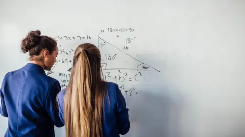 Getty Images Pupils doing maths on a whiteboard