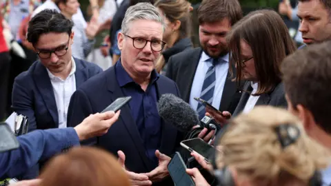 Reuters Sir Keir Starmer speaking to journalists on a campaign visit in Little Horwood, Buckinghamshire