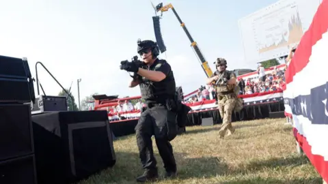 Getty Images Armed police react after Crooks shoots at Trump