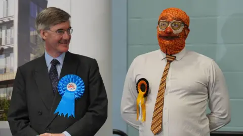 PA Media Jacob Rees Mogg and another candidate in his constituency. Neither won.