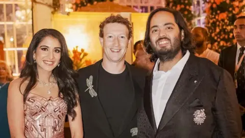 Reuters Meta CEO Mark Zuckerberg poses with Anant Ambani, son of Mukesh Ambani, the Chairman of Reliance Industries, and Radhika Merchant, daughter of industrialist Viren Merchant, during their pre-wedding celebrations in Jamnagar, Gujarat, India, March 2, 2024