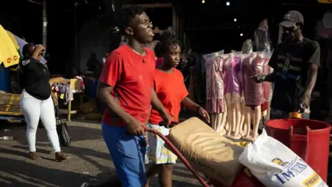 Reuters People buy supplies at the downtown street market as Hurricane Beryl approaches, in Kingston, Jamaica, July 2, 2024.