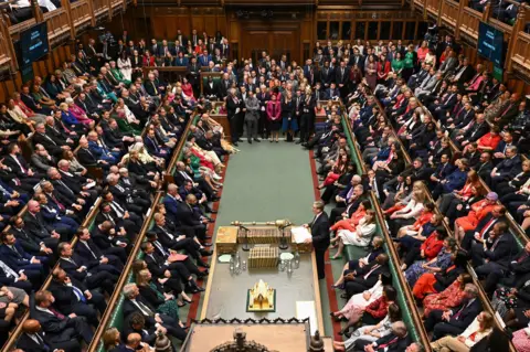 House of Commons A packed House of Commons chamber, with many MPs standing