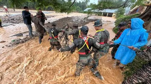 Getty Images Army officials, emergency teams and civilians help rescue people at the disaster site where a landslide occured and destroyed hundreds of houses, resulting in mass fatalities in Wayanad region