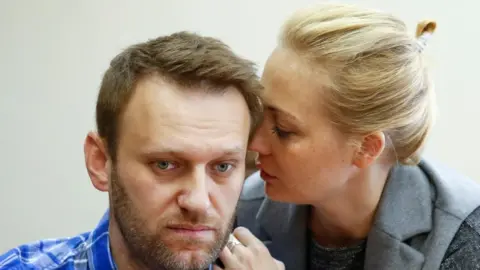 REUTERS/Tatyana Makeyeva/File Photo Alexei Navalny is seen with his wife Yulia appearing to whisper into his ear