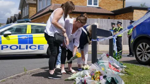 PA Media People lay flowers in Ashlyn Close