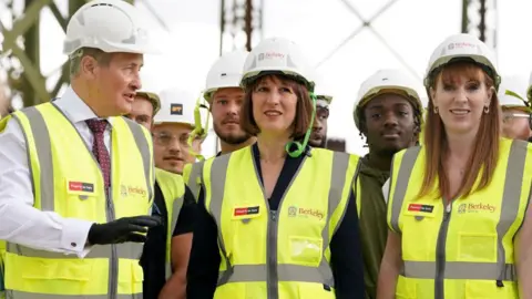 Getty Images Rachel Reeves and Angela Rayner wearing high-vis jackets and hard hats on a visit to the Oval Village project in London 