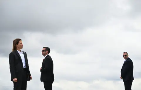 Getty Images US Secret Service agent stand at their posts while waiting for the arrival of US President Joe Biden at Atlanta Hartsfield-Jackson International Airport