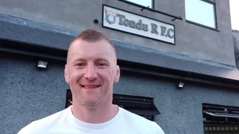 Hywel Davies, assistant coach, stood by the Tondu RFC entrance