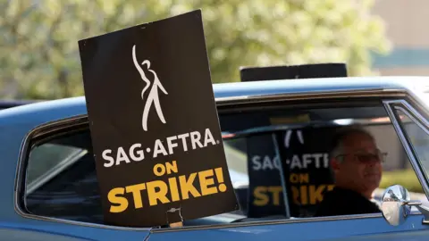 Reuters A mid shot of a sign saying "SAG AFTRA on STRIKE!"