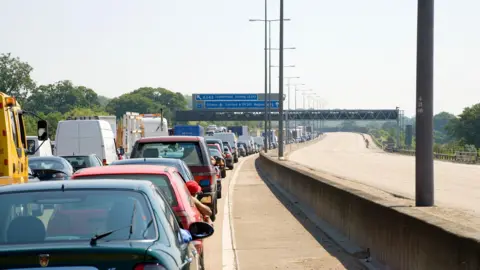 Getty Images Cars queueing in traffic on one side of the M25, while the motorway in the other direction is empty