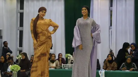 Shukri Mohamed Abdi Two women on a catwalk