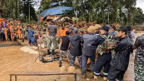 Arun Chandra Bose Rescue teams use ropes to cross a broken bridge and reach survivors in Wayanad