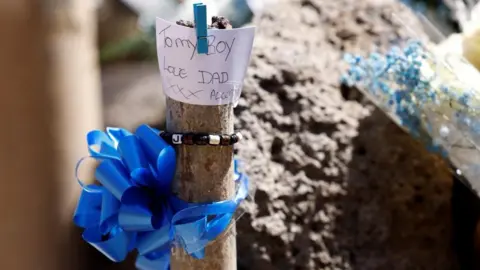 Reuters Floral tributes left near where Jay Slater's body was found