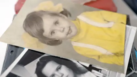 BBC / Francis's family archive Picture of Francis as a child dressed as a girl, wearing a a yellow top with hair in bunches